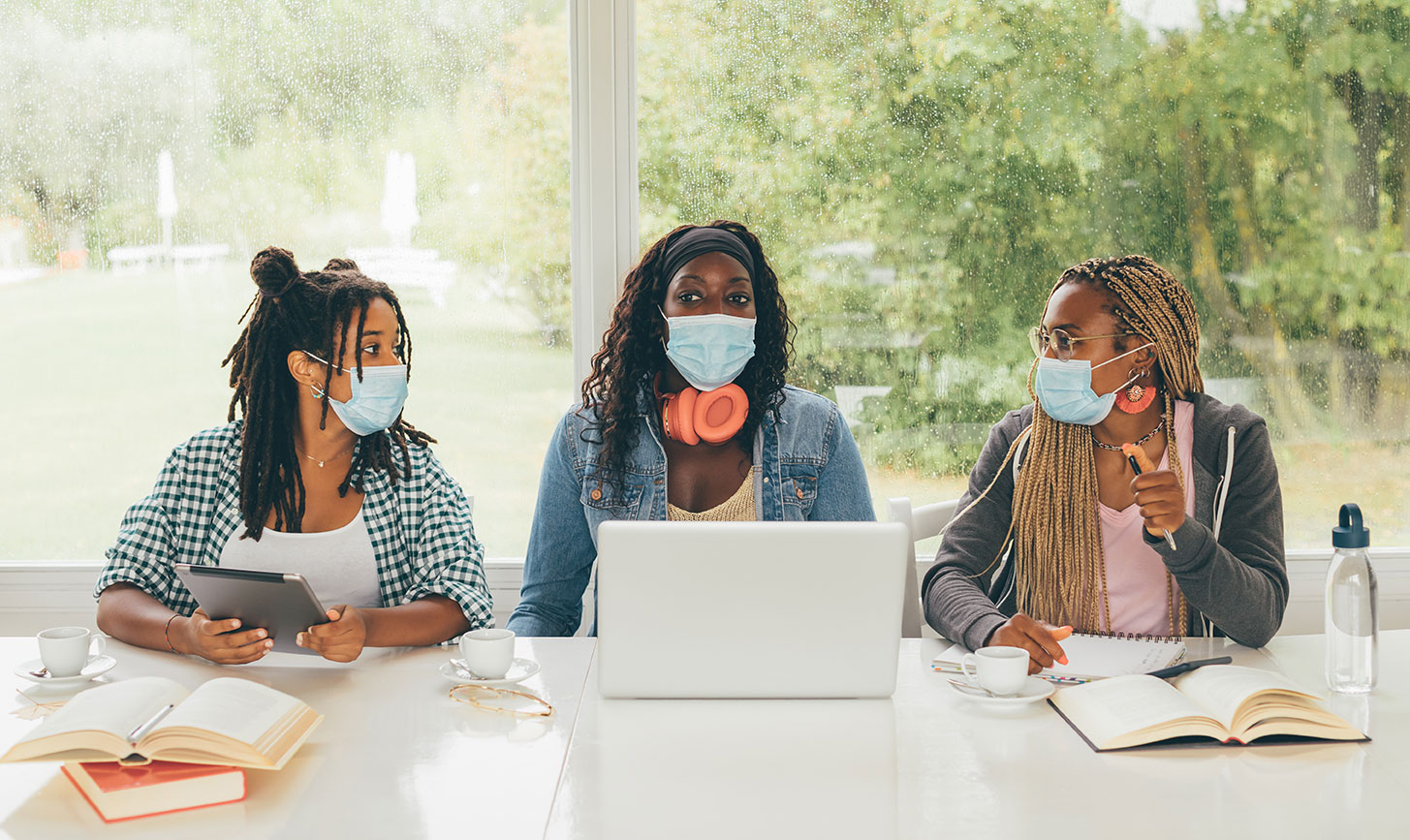 students-with-masks-working-together-sitting.jpg